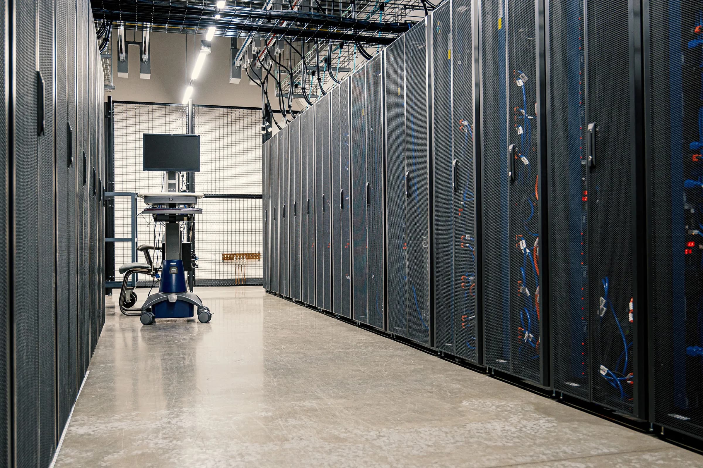 Rows of server cabinets along a data center aisle